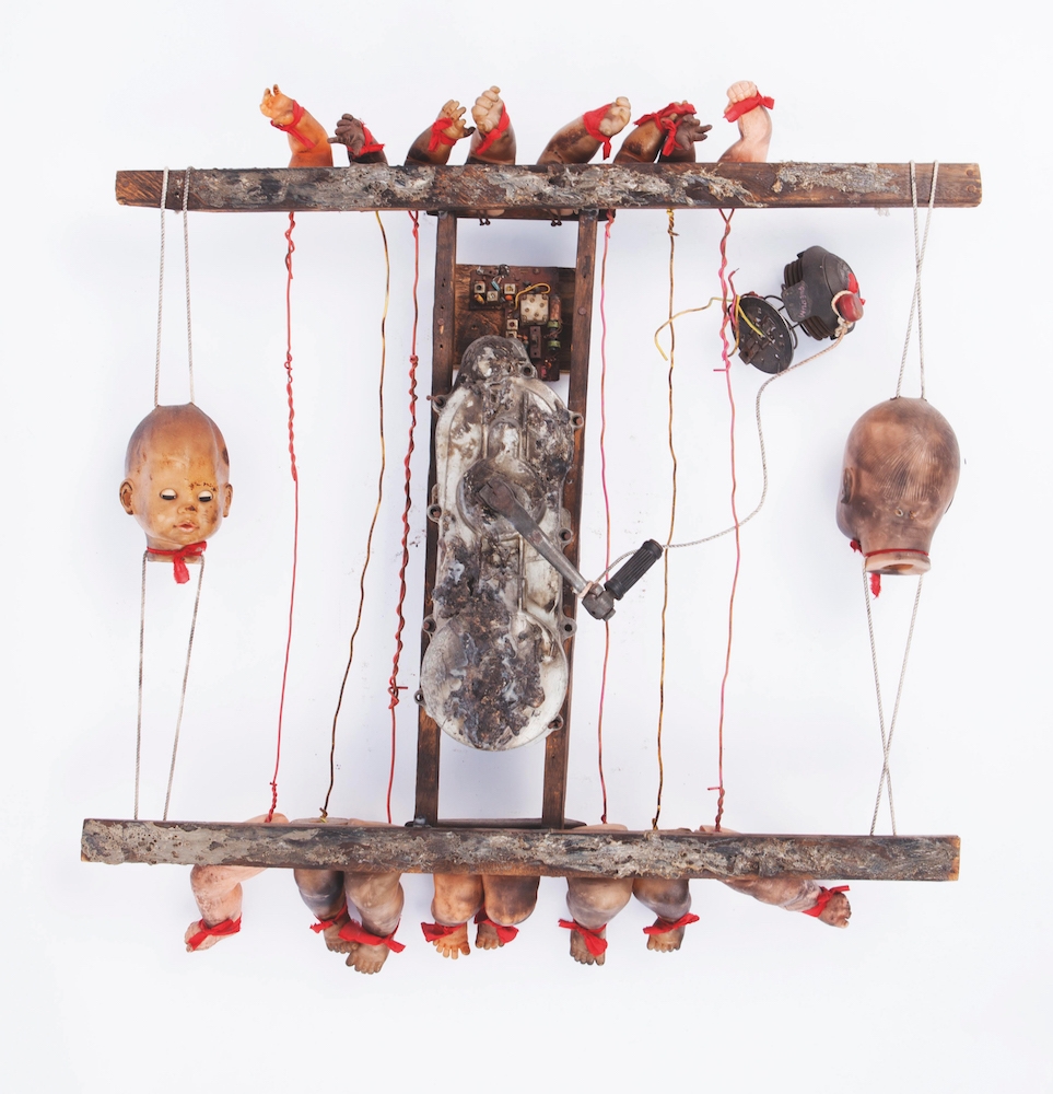 Gérard Quenum, Voyageur, 1999. Bois, métal et têtes de poupées, 115 x 87 x 11 cm. Courtesy Galerie Vallois