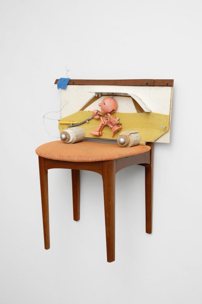 (15 Brian Griffiths, Foot Down with Mustard Car (No No to Knock-Knocks), 2023, wood, plywood, hardboard, cardboard, aluminium, plastic, paint, fabric, tape, wire, chair, fixtures and fittings, 72 x 63 x 48 cm, unique